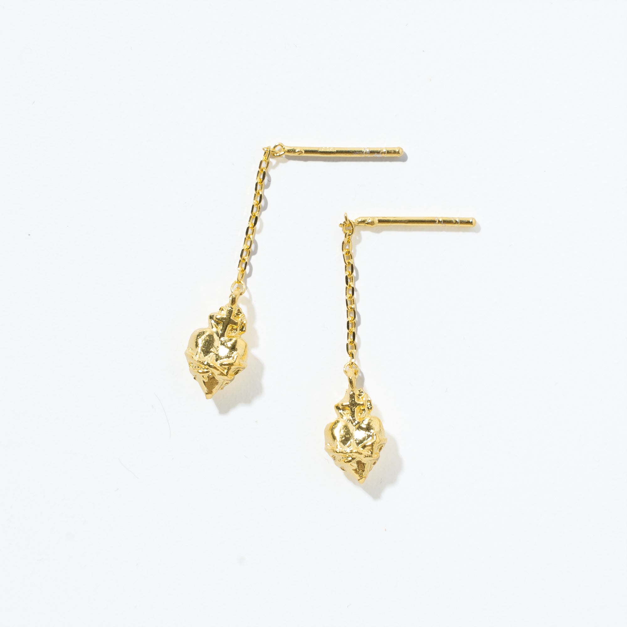 A pair of gold plated sterling silver scared heart earrings suspended from a sterling silver chain.